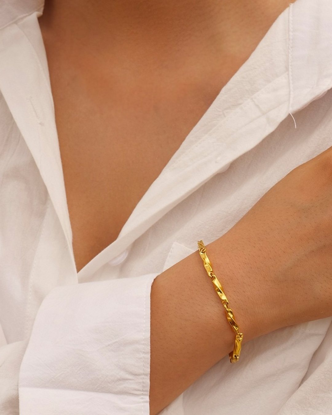 Minimal twist bracelet styled on a feminine wrist
