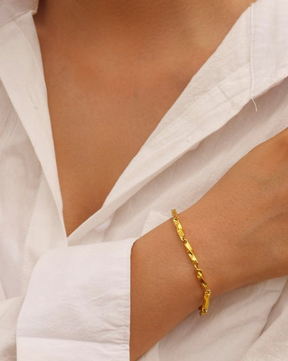 Minimal twist bracelet styled on a feminine wrist