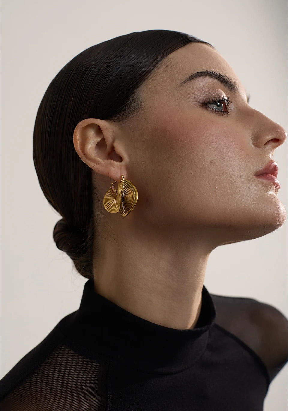 Gold flowing spiral drop earrings, sculptural design