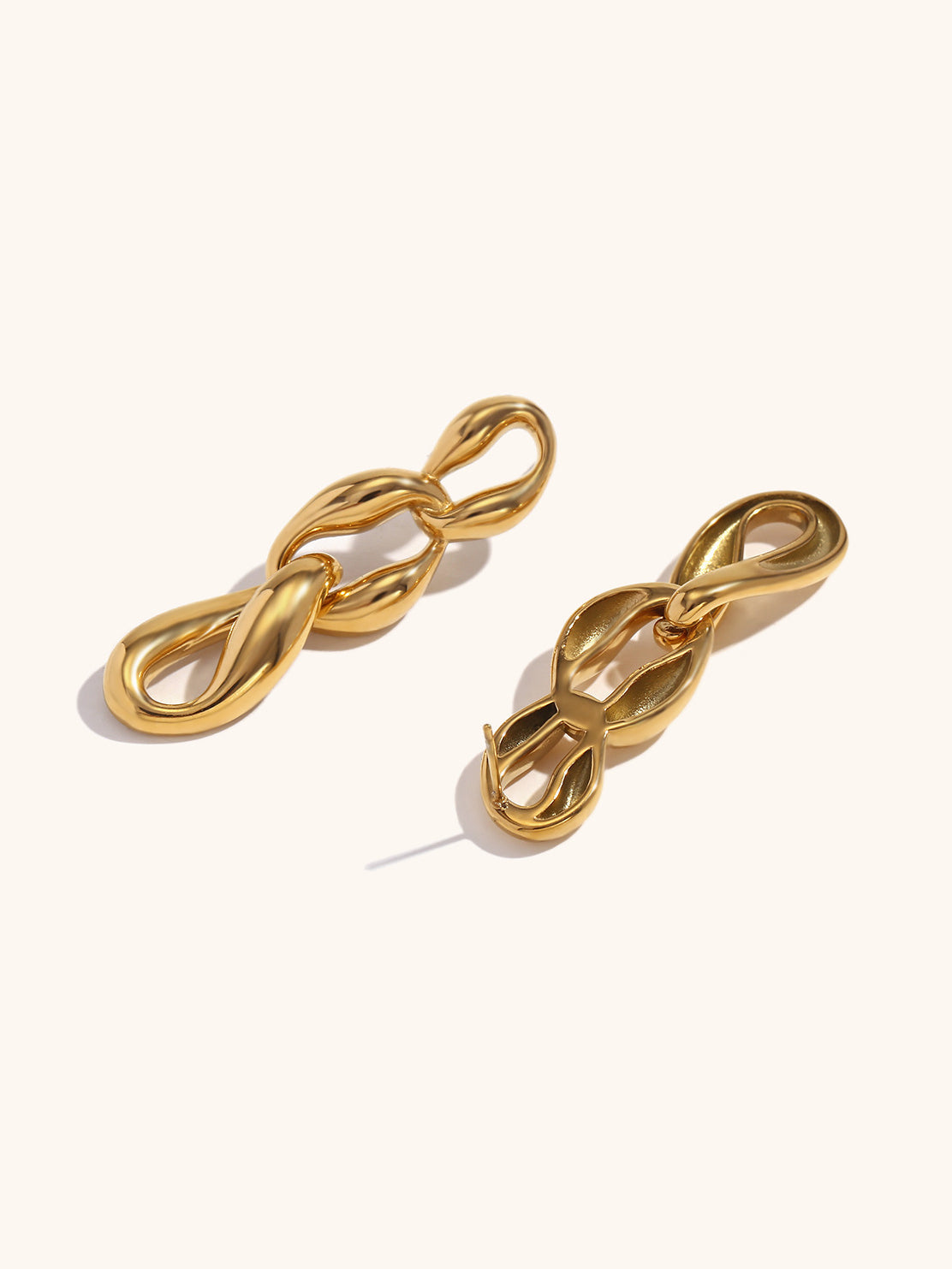 Close-up of layered gold chain link earring detail