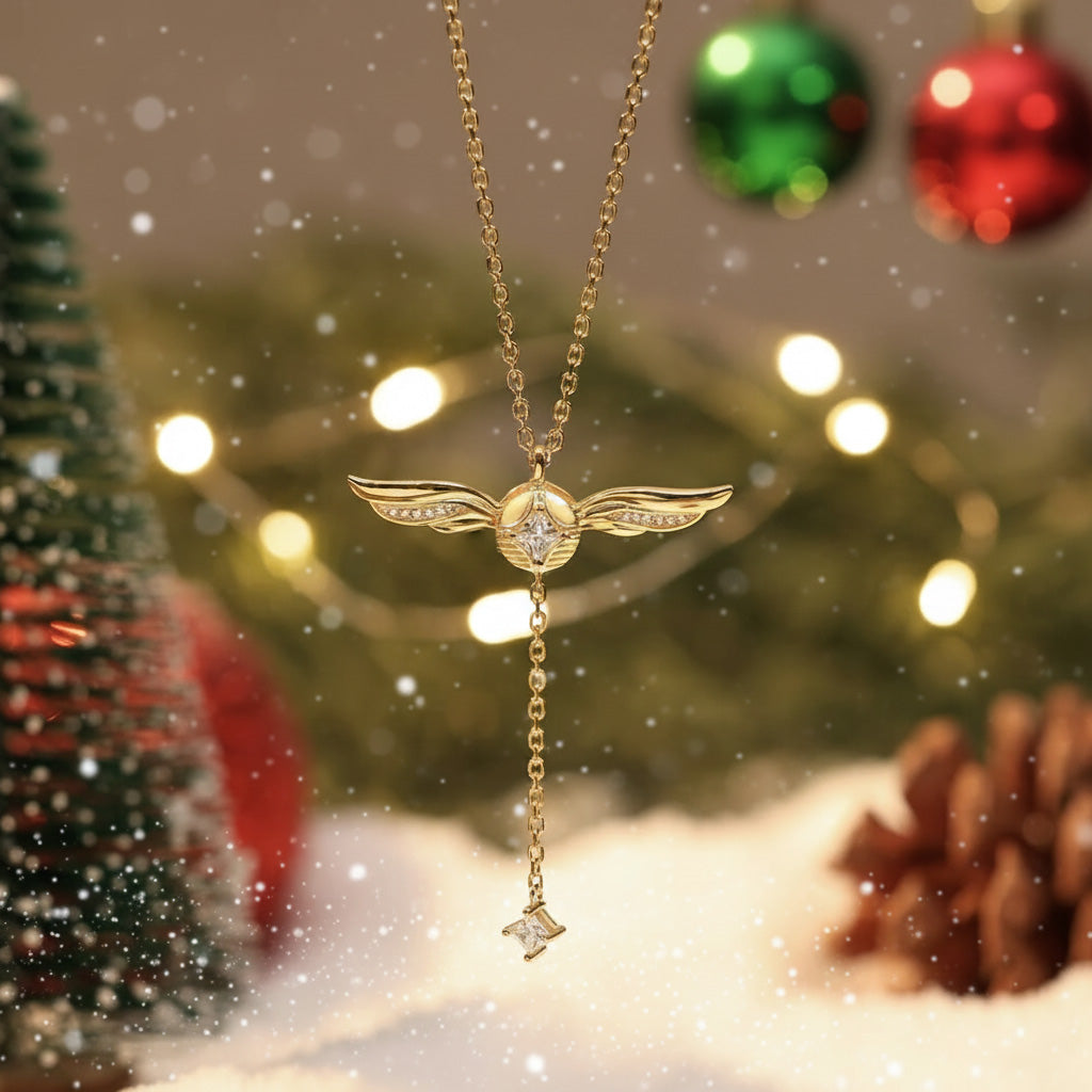 Gold-plated lariat necklace worn on model, winged crystal pendant at chest