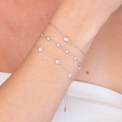 Close-up of gold clover charm bracelet detail