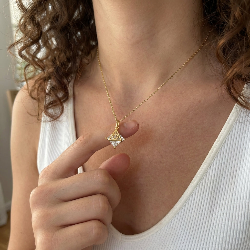 Front view of Deathly Hallows necklace with symbolic triangle charm and clear gemstone detail