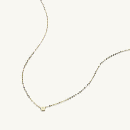 Letter dot pendant in gift packaging