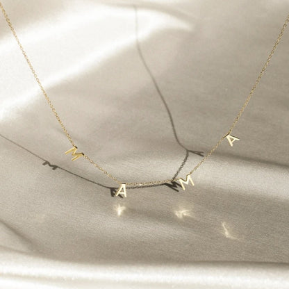 Gold Mama pendant on neutral background
