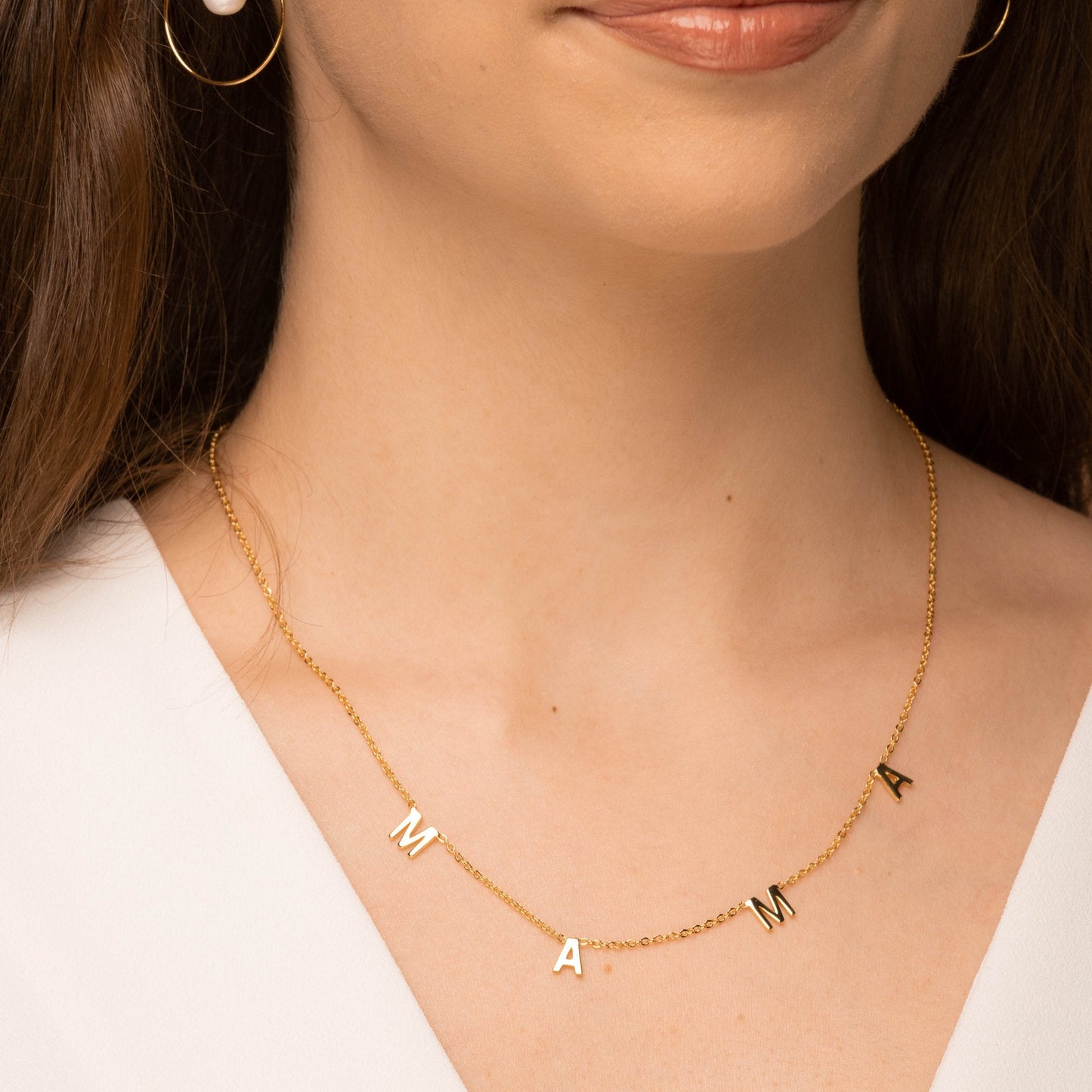 Mama necklace styled on a feminine neckline