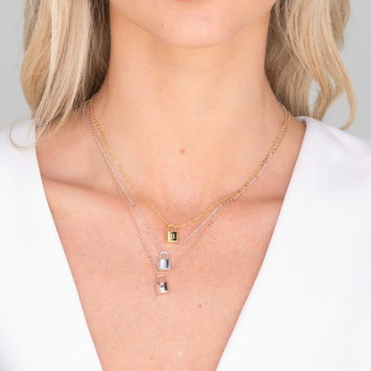 Close-up of gold padlock initial pendant