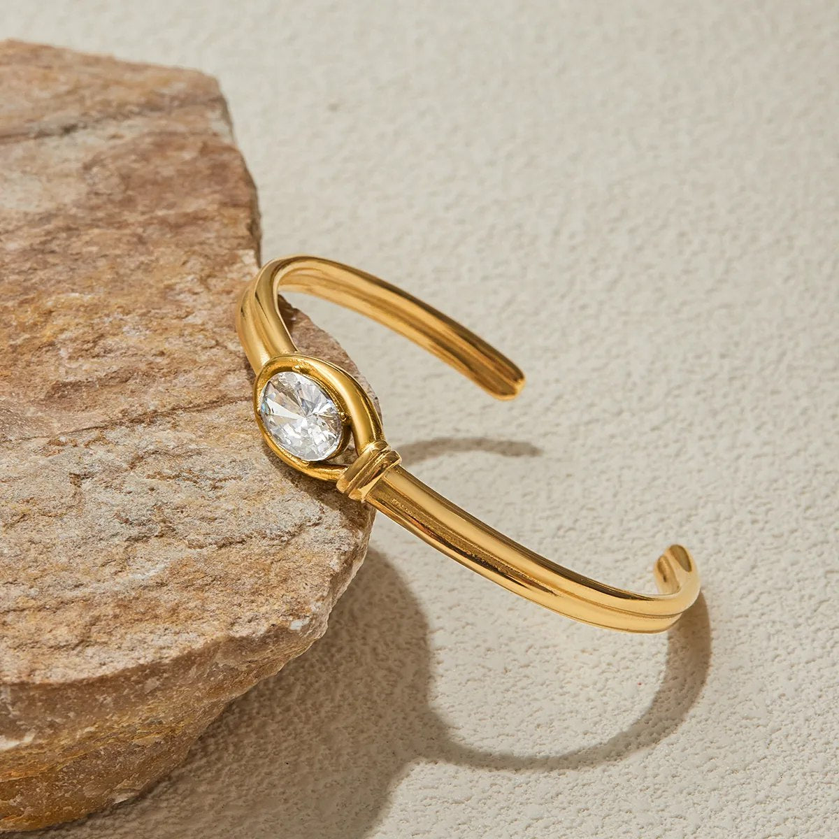 Close-up of oval crystal gold cuff detail