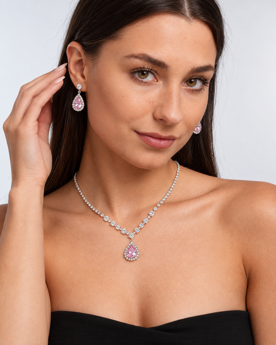 Crystal Teardrop Necklace & Earring Set in Silver / Pink, worn by a model in a three-quarter portrait - Ravyena