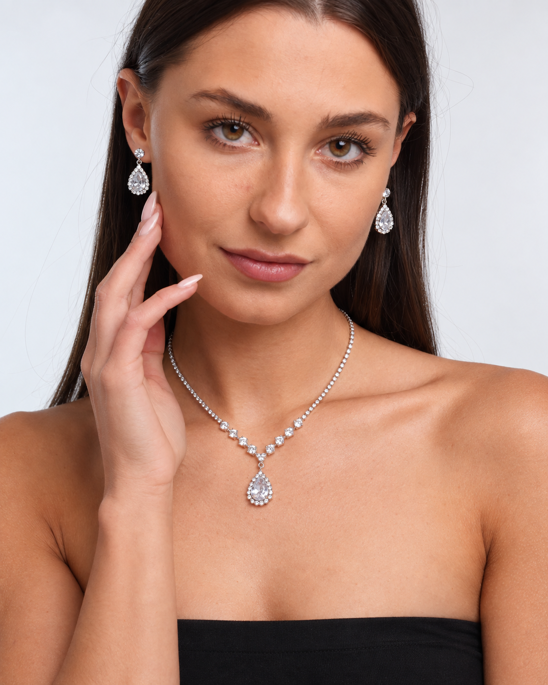 Crystal Teardrop Necklace & Earring Set in Silver / Clear, worn by a model in a front portrait - Ravyena