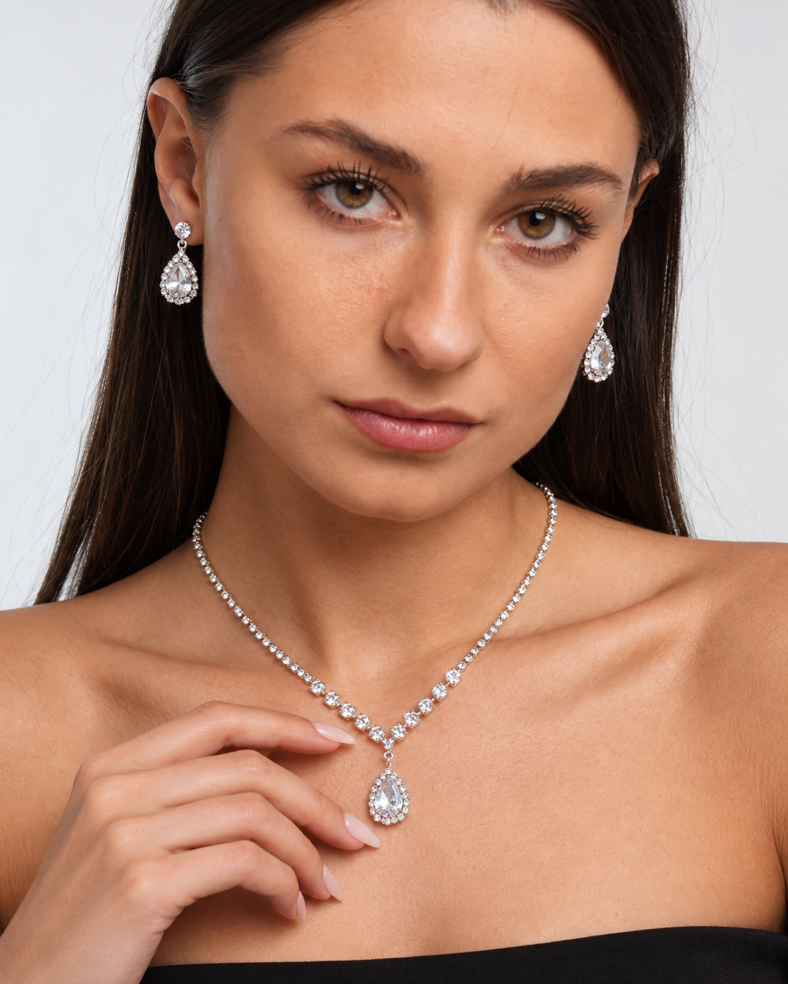 Crystal Teardrop Necklace & Earring Set in Silver / Clear, worn by a model in a close-up - Ravyena