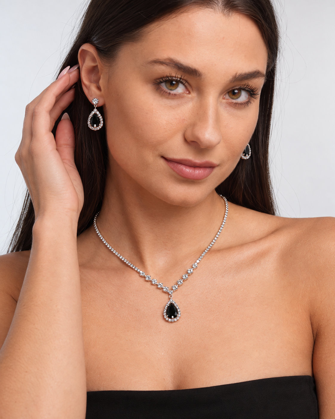 Crystal Teardrop Necklace & Earring Set in Silver / Black, worn by a model in a three-quarter portrait - Ravyena