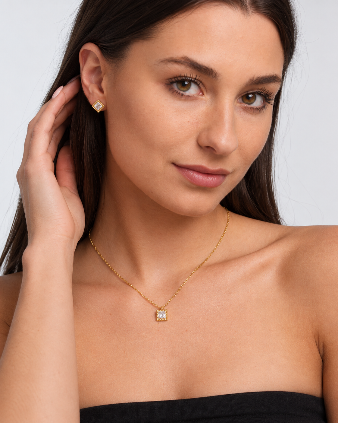 Gold Square Crystal Necklace & Stud Earring Set in Gold, worn by a model in a three-quarter portrait - Ravyena