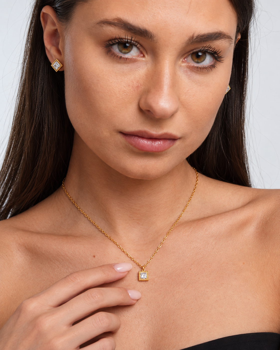 Gold Square Crystal Necklace & Stud Earring Set in Gold, worn by a model in a close-up - Ravyena
