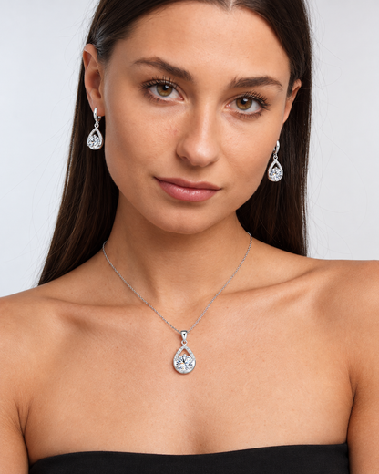 Silver-Tone Teardrop Crystal Necklace & Earring Set in Clear, worn by a model in a front portrait - Ravyena