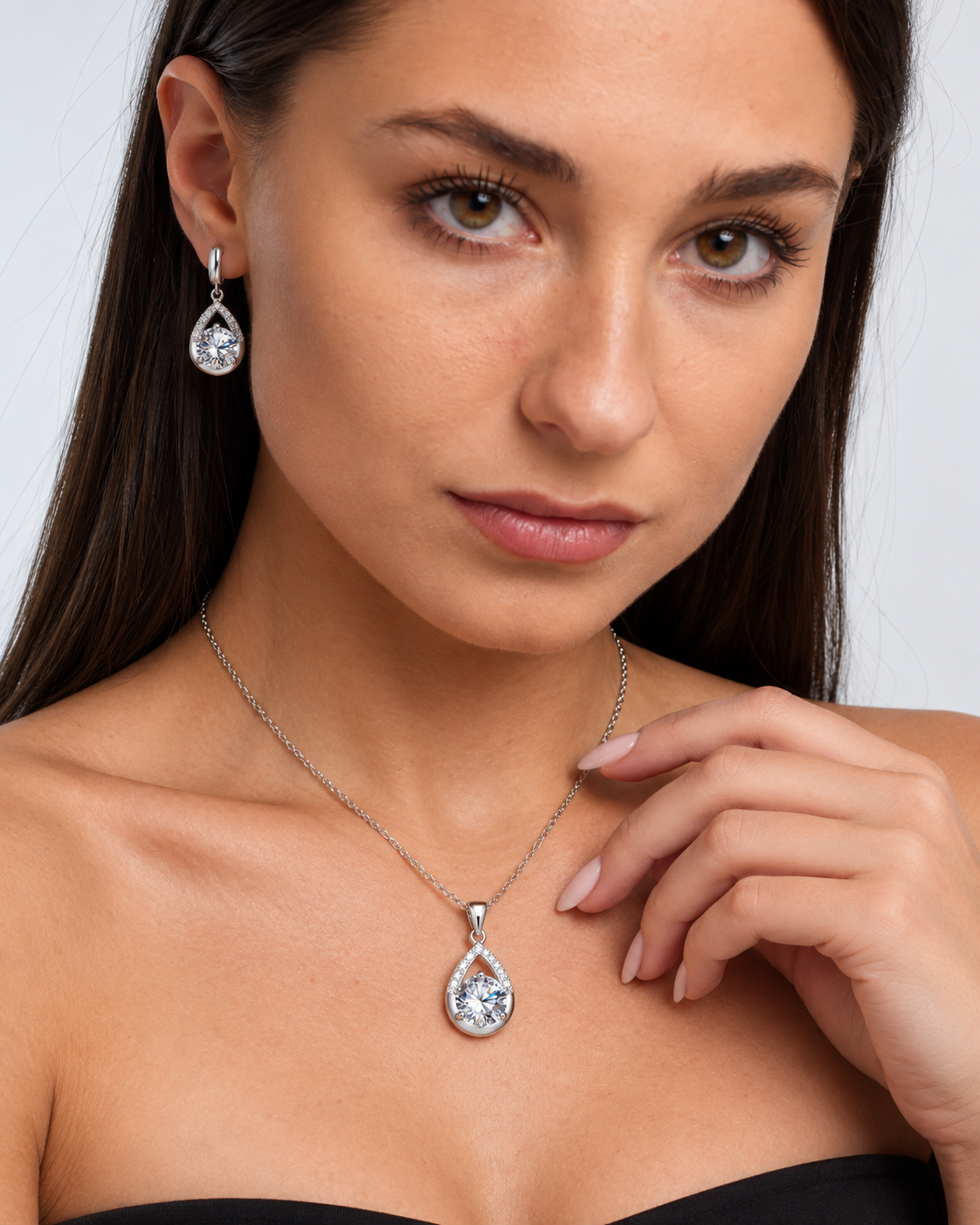 Silver-Tone Teardrop Crystal Necklace & Earring Set in Clear, worn by a model in a close-up - Ravyena