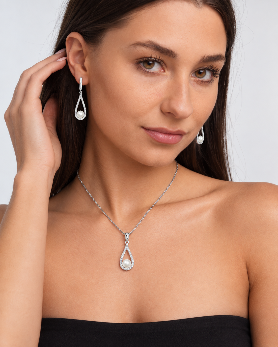 Pearl Teardrop Necklace & Earring Set in Silver, worn by a model in a three-quarter portrait - Ravyena