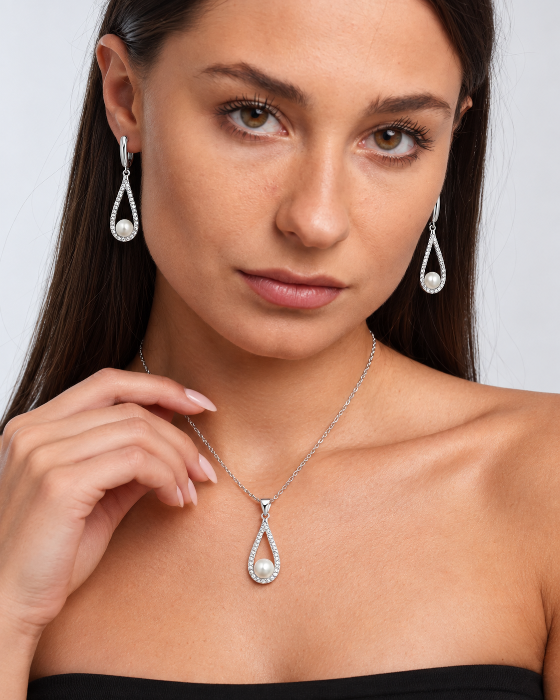 Pearl Teardrop Necklace & Earring Set in Silver, worn by a model in a close-up - Ravyena