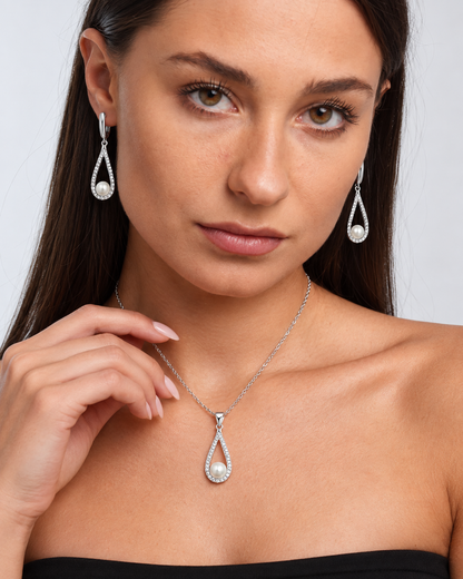 Pearl Teardrop Necklace & Earring Set in Silver, worn by a model in a close-up - Ravyena