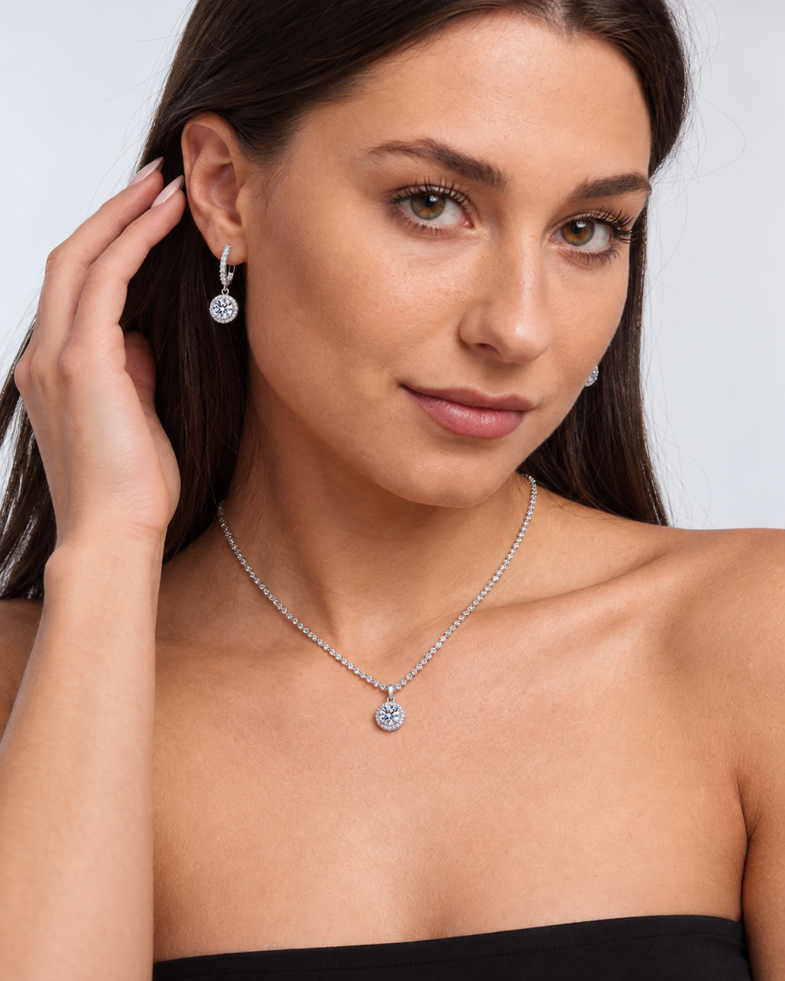 925 Sterling Silver Round Crystal Necklace & Earring Set in Clear, worn by a model in a three-quarter portrait - Ravyena