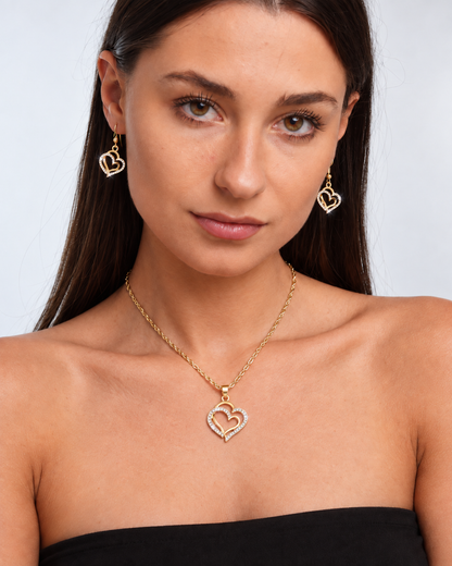Double Heart Crystal Necklace & Earring Set in Gold, worn by a model in a front portrait - Ravyena