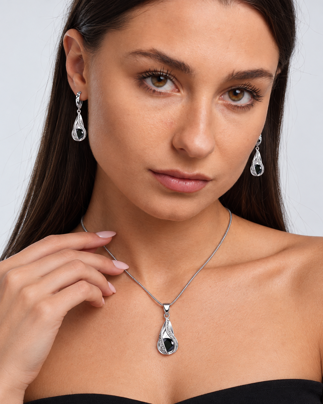 Black Crystal Twist Necklace & Earring Set in Black, worn by a model in a close-up - Ravyena