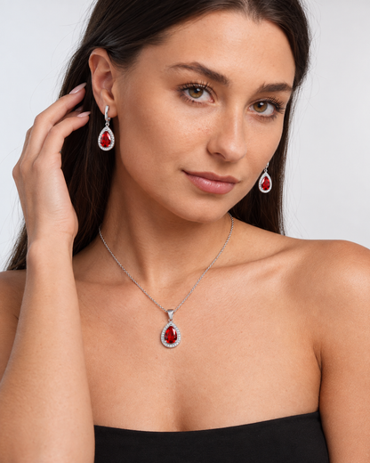 Colour Crystal Teardrop Necklace & Earring Set in Red, worn by a model in a three-quarter portrait - Ravyena