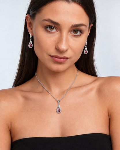 Twist Teardrop Crystal Necklace & Earring Set in Red, worn by a model in a front portrait - Ravyena