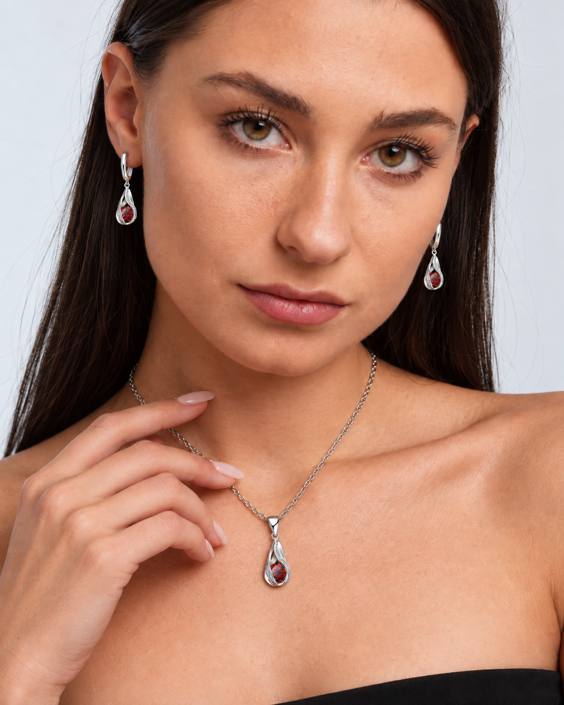 Twist Teardrop Crystal Necklace & Earring Set in Red, worn by a model in a close-up - Ravyena