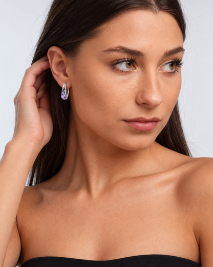 Sterling Silver Colour Crystal Hoop Earrings in Purple, worn by a model in a three-quarter portrait - Ravyena