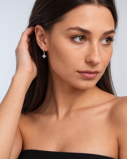 925 Sterling Silver Crystal Flower Hoop Earrings in Silver, worn by a model in a three-quarter portrait - Ravyena