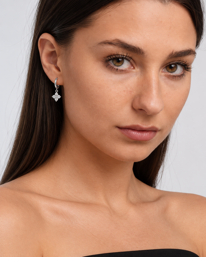 925 Sterling Silver Crystal Flower Hoop Earrings in Silver, worn by a model in a close-up - Ravyena