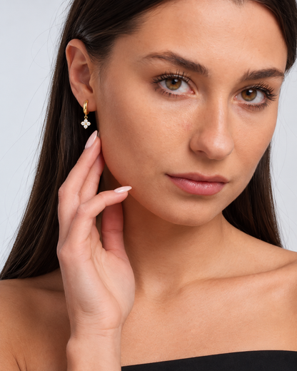 925 Sterling Silver Crystal Flower Hoop Earrings in Gold, worn by a model in a close-up - Ravyena