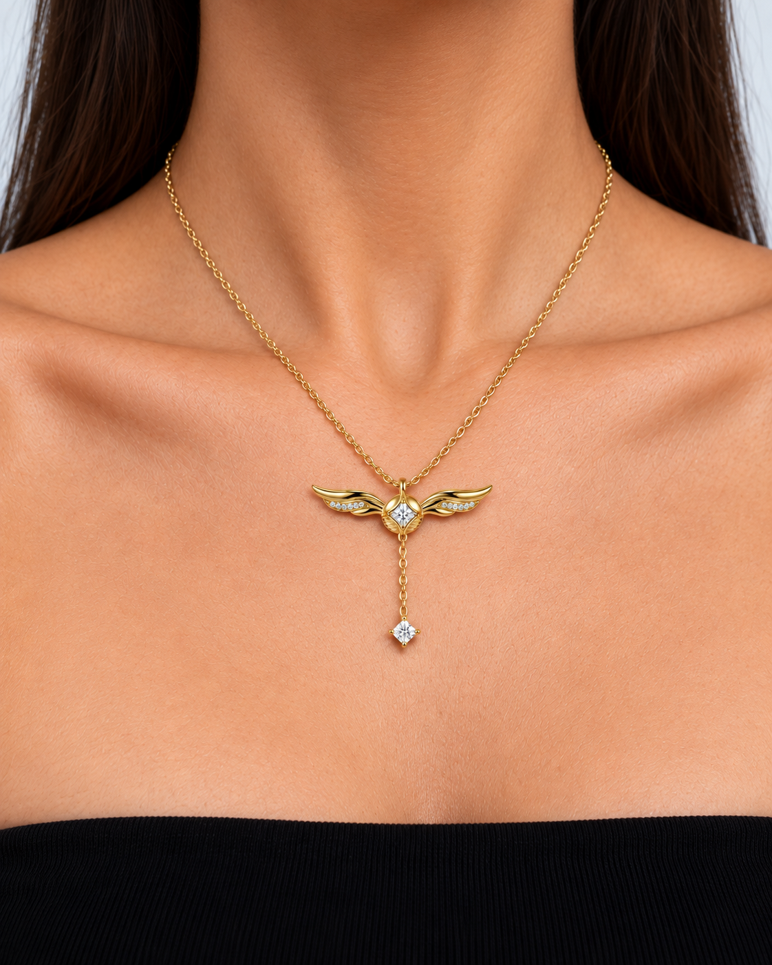 Winged Crystal Gold Lariat Y Necklace in a gold finish worn by a model, close-up jewellery detail