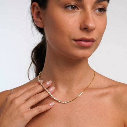 Crystal tennis necklace styled on a model's neckline