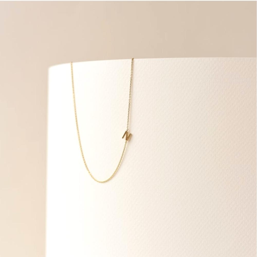 Sideways initial necklace variation D in 18K gold