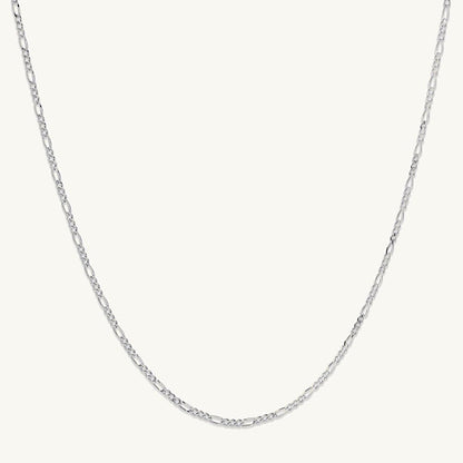 Gold figaro chain on neutral background