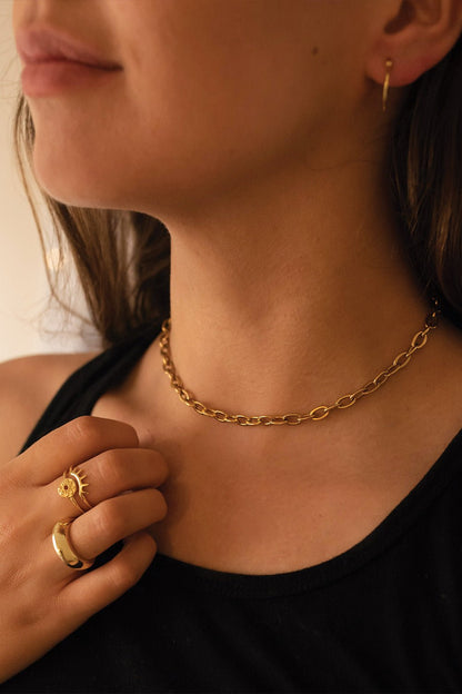 Close-up of geometric gold hoop earring detail