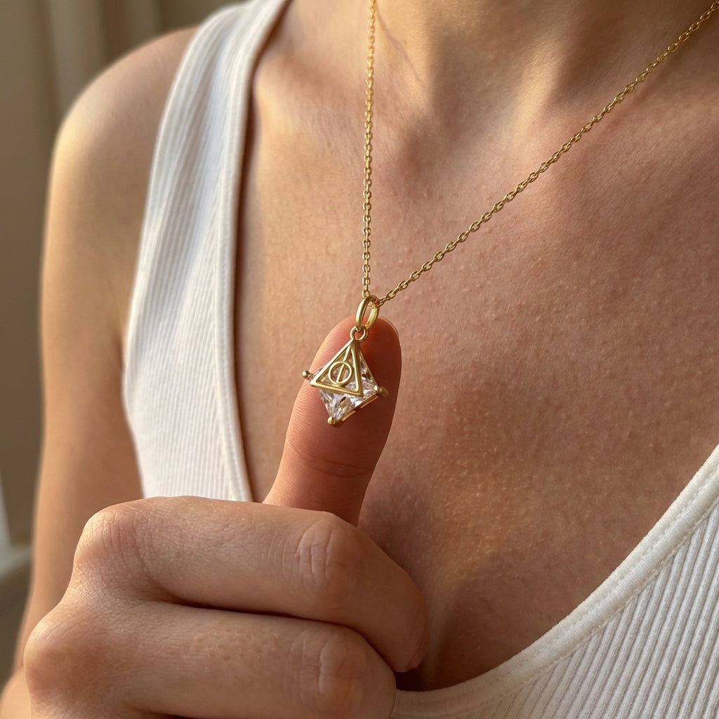 Sterling silver Deathly Hallows necklace with polished gold finish and suspended crystal stone