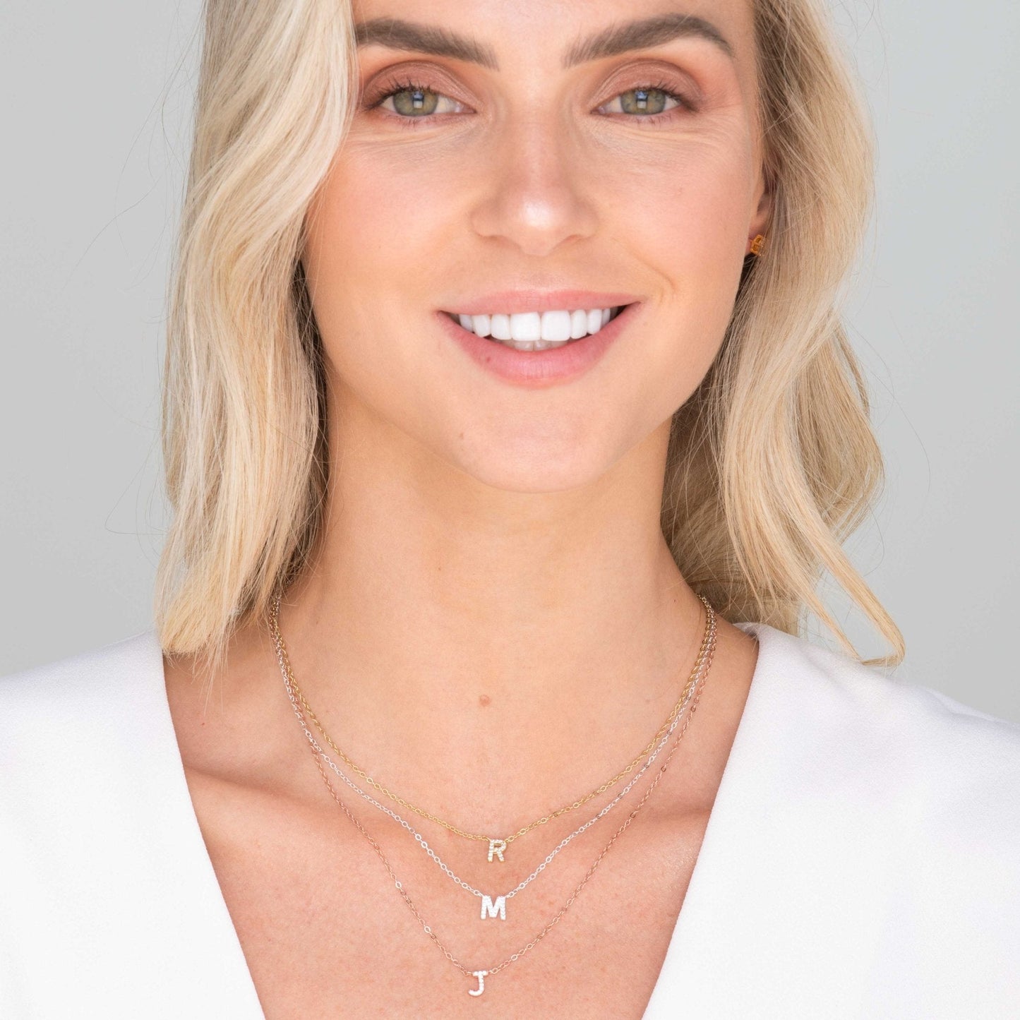 Initial Sapphire Letter Necklace worn styled on neckline – Ravyena
