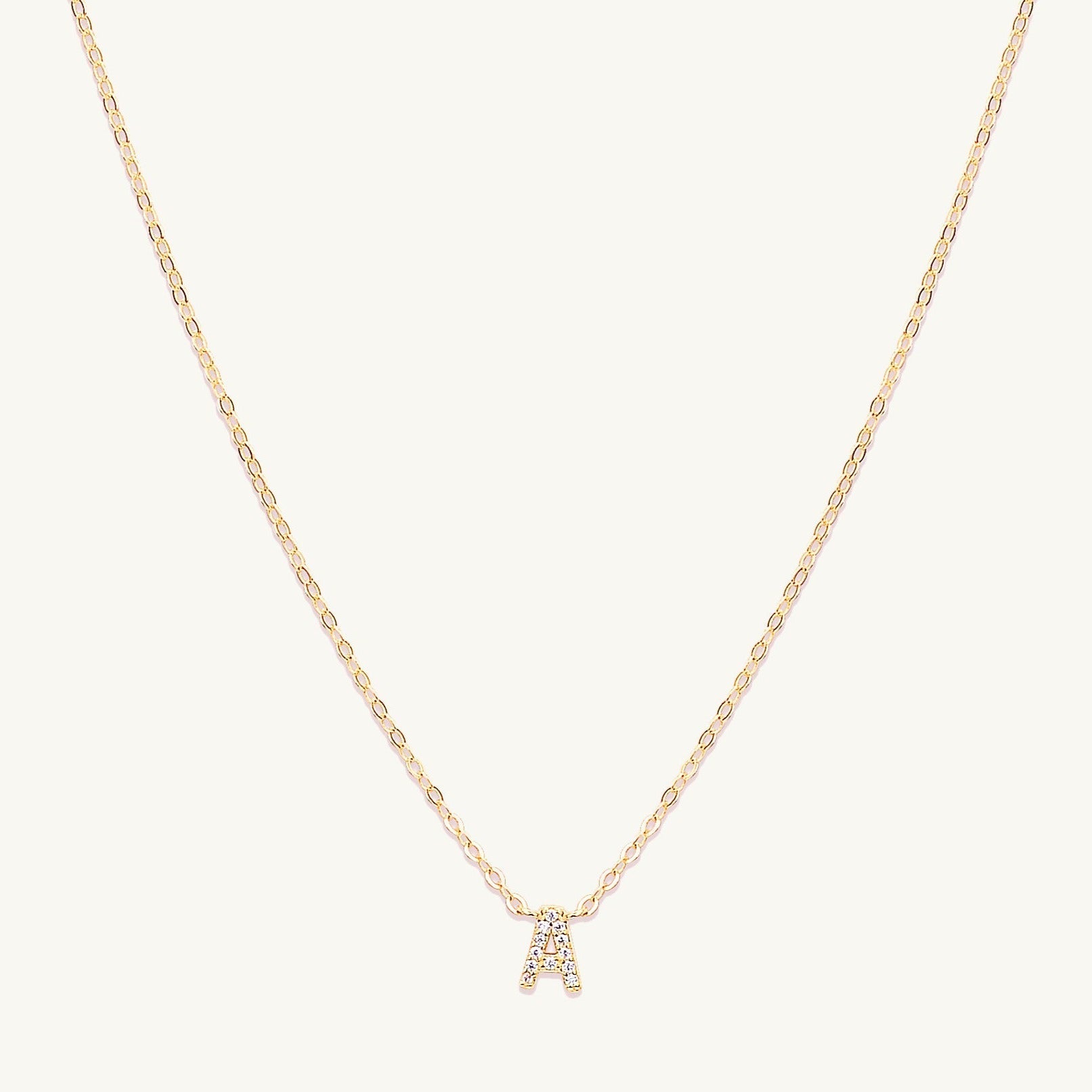 Sapphire letter necklace variation H on a delicate gold chain