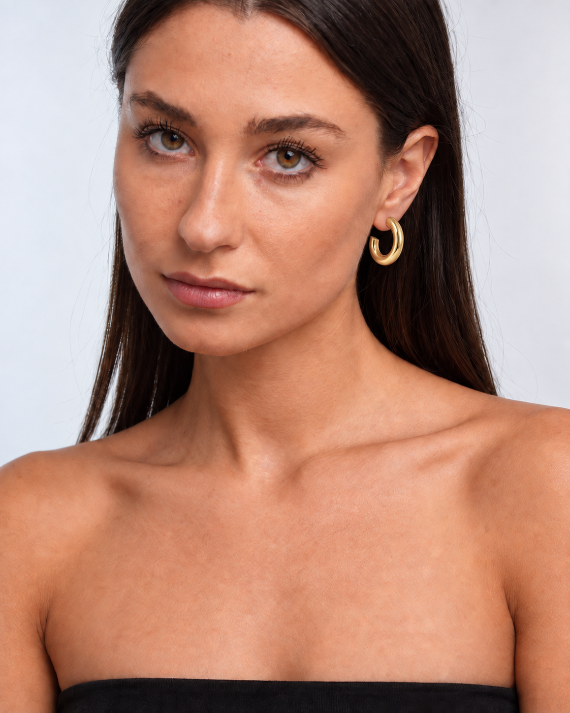 Chunky 14K Gold Statement Hoop Earrings worn by a brunette model - hero view